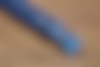 Close up detail of the twist on the top of the blue pen.